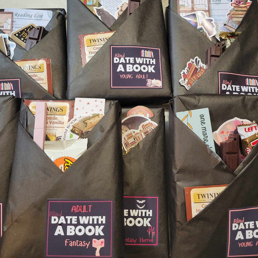 Black gift bags with book-themed labels and images of books on a white background