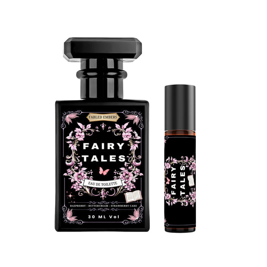 Sleek black perfume bottle with an ornate label featuring pink floral vines, a small pink butterfly, and a tiny open book. The fragrance is named "Fairy Tales" and has notes of Raspberry, Buttercream, and Strawberry Cake.