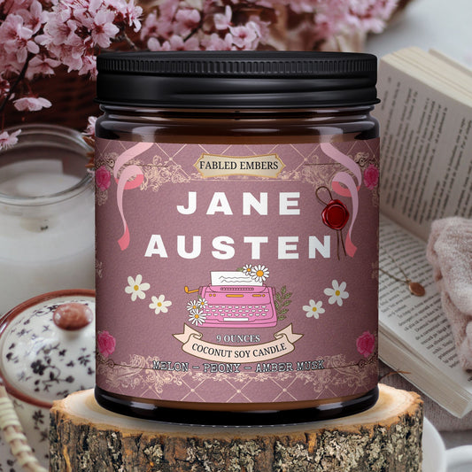 Step into a Regency romance with our "Jane Austen" coconut soy candle. Its elegant label features a vintage pink typewriter, delicate daisies, and rose-adorned scrolls on a charming damask background. Scented with melon, peony, and amber, it's perfect for your literary escape.