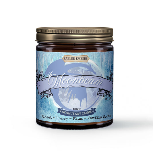 Amber jar "Moonbeam" candle. The luminous blue label showcases a prominent celestial moon with a flowing banner and delicate floral accents. Scent notes: Violet, honey, plum, vanilla woods. Ideal for fantasy book lovers, dragon enthusiasts, and romantasy readers.
