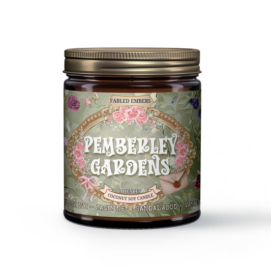 Amber jar candle with a green label featuring an ornate gold frame, pink roses, green foliage, and a small sealed letter with a pink ribbon. The candle is named "Pemberley Gardens" and has scent notes of English Ivy, Jasmine, Sandalwood, and Vanilla.
