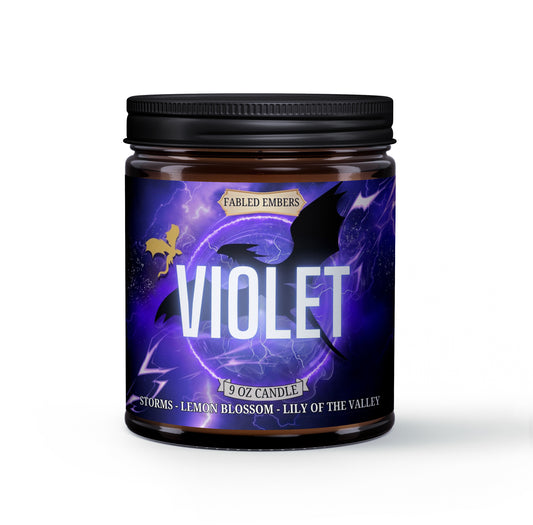 A jar candle with a black lid, labeled 'VIOLET' with a description of the scent profile including 'storms', 'earth', 'lily of the valley', and 'soft citrus'.