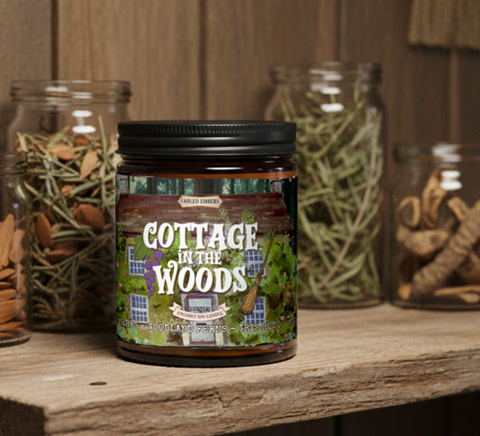 Jar labeled 'Cottage in the Woods' on a wooden surface with jars containing dried herbs in the background.