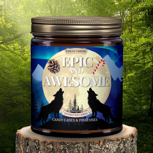 "Epic and Awesome" coconut soy candle. The striking label showcases wolves howling under a moonlit, aurora-filled sky,  with pine trees, snow-capped mountains, and a vibrant sky. Includes a candy cane and pinecone graphic. Bronze lid.
