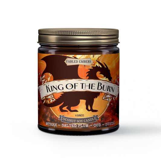 Unleash your inner monarch with this captivating 4oz coconut soy candle. Its dynamic label features a powerful dragon silhouette against a fiery, molten backdrop, evoking epic tales and untamed realms. Experience the rich, complex aroma of Myrrh, the unique depth of Salted Plum, luxurious Oud, and the soft allure of Suede. Perfect for setting an adventurous mood in your lair.