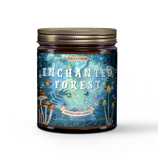 ENCHANTED FOREST smells like moss and mist with patchouli and woodland rose. 4oz coconut soy wax candle. Its label showcases magical forest scenes with bright butterflies and enchanting mushrooms, ideal for cottagecore decor.