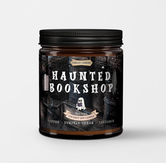 Candle jar labeled 'Haunted Bookshop' with a black lid on a light gray background