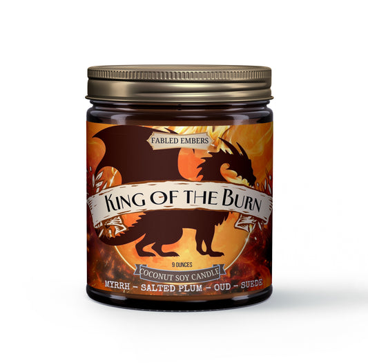 Unleash your inner monarch with this captivating 9oz coconut soy candle. Its dynamic label features a powerful dragon silhouette against a fiery, molten backdrop, evoking epic tales and untamed realms. Experience the rich, complex aroma of Myrrh, the unique depth of Salted Plum, luxurious Oud, and the soft allure of Suede. Perfect for setting an adventurous mood in your lair.