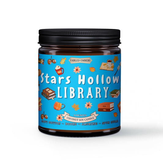 Candle jar labeled 'Stars Hollow Library' with a blue label featuring illustrations on a white background.