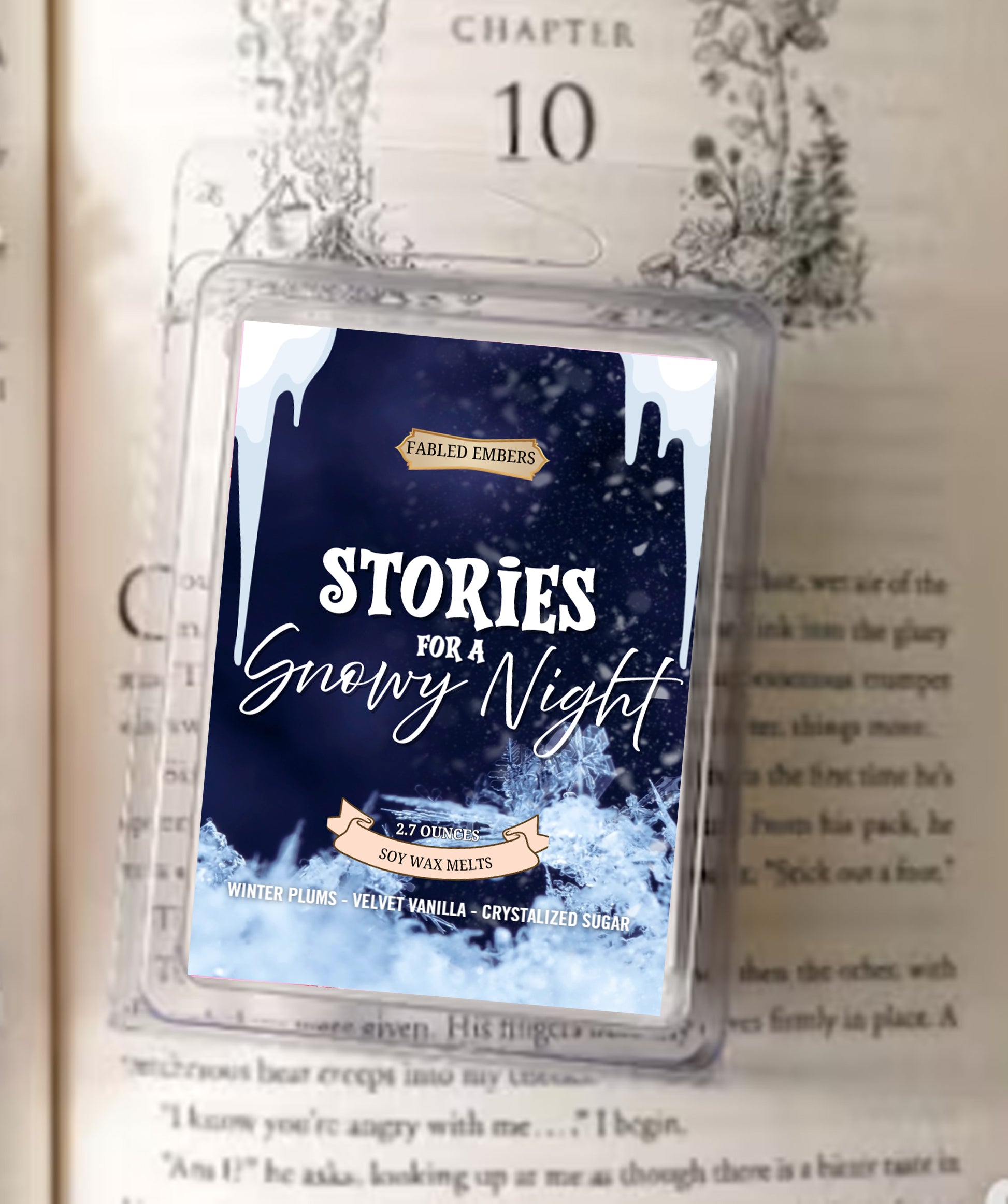 Scented wax melt packaging labeled 'Stories for a Snowy Night' on a book page.