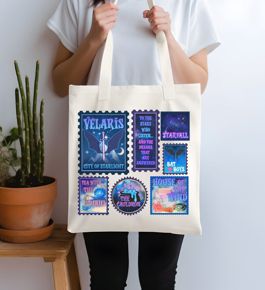 Person holding a tote bag with colorful designs and text against a white background